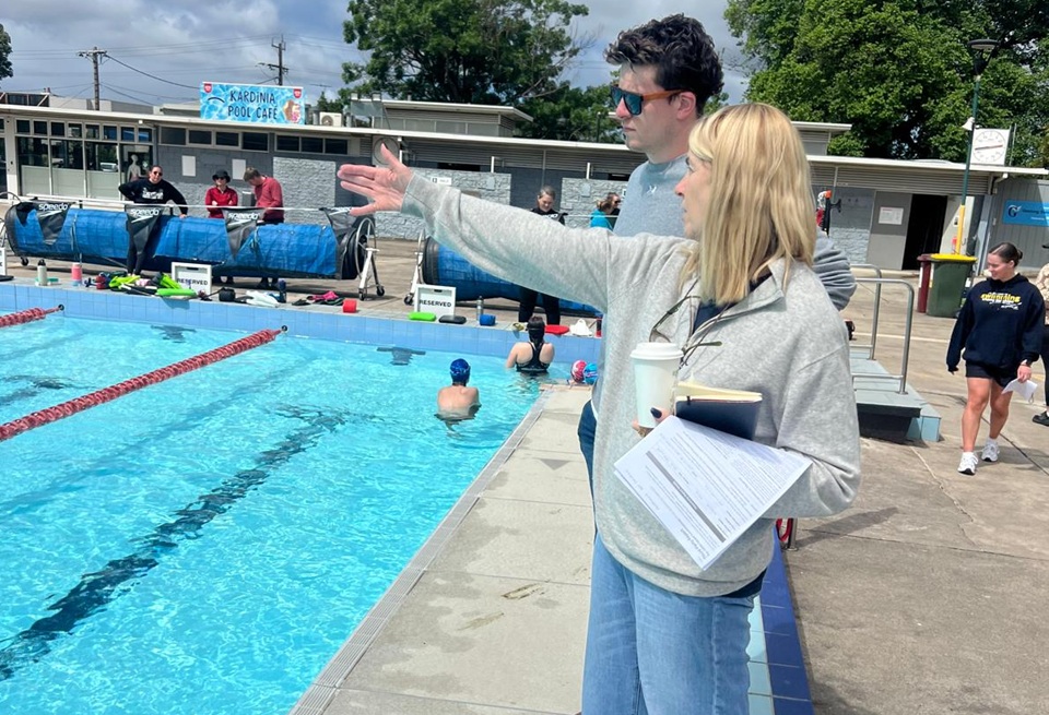 Swim coaches Will and Jo at the side of a pool