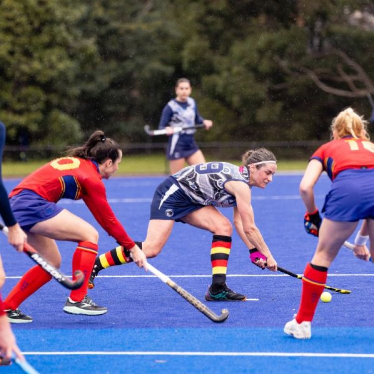 Women playing hockey.