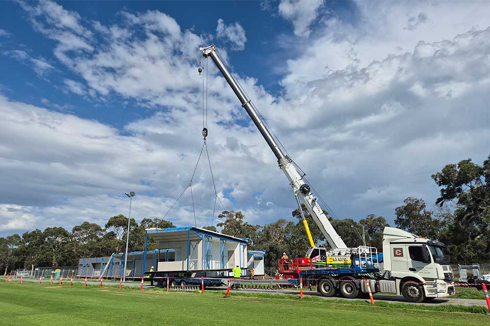 A crane-truck delivers displacement facilities for Power House Rugby Union Club.