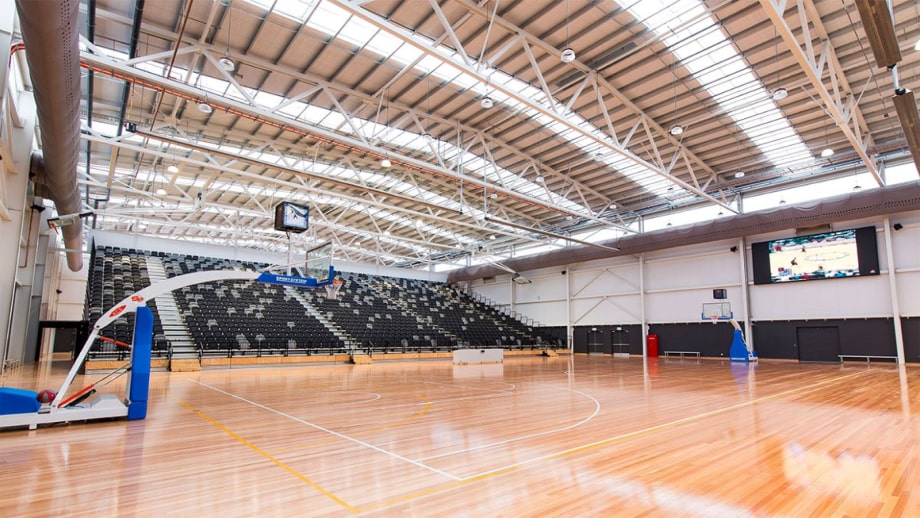 The inside of the Gippsland Regional Indoor Sports Stadium set up for a basketball game.