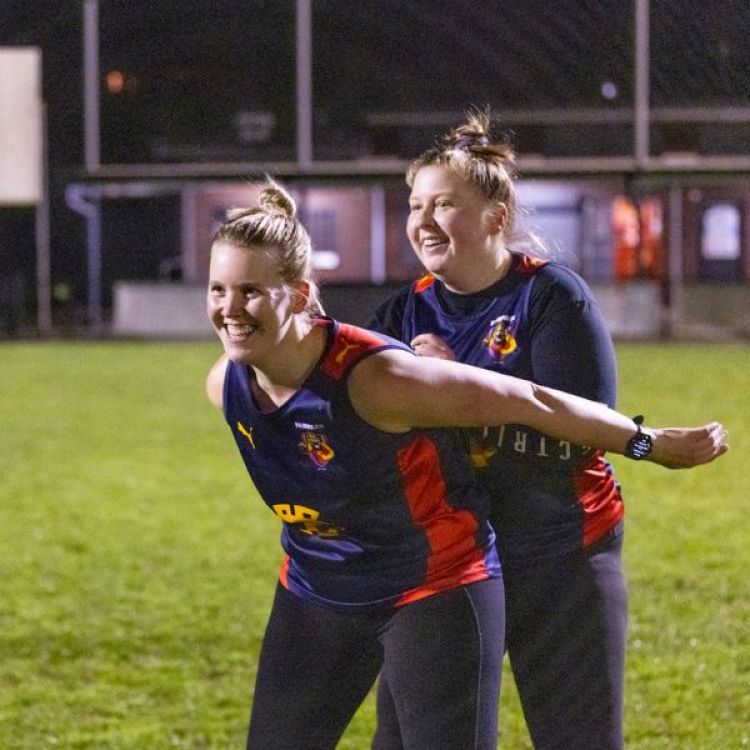 Women at football training under lights.