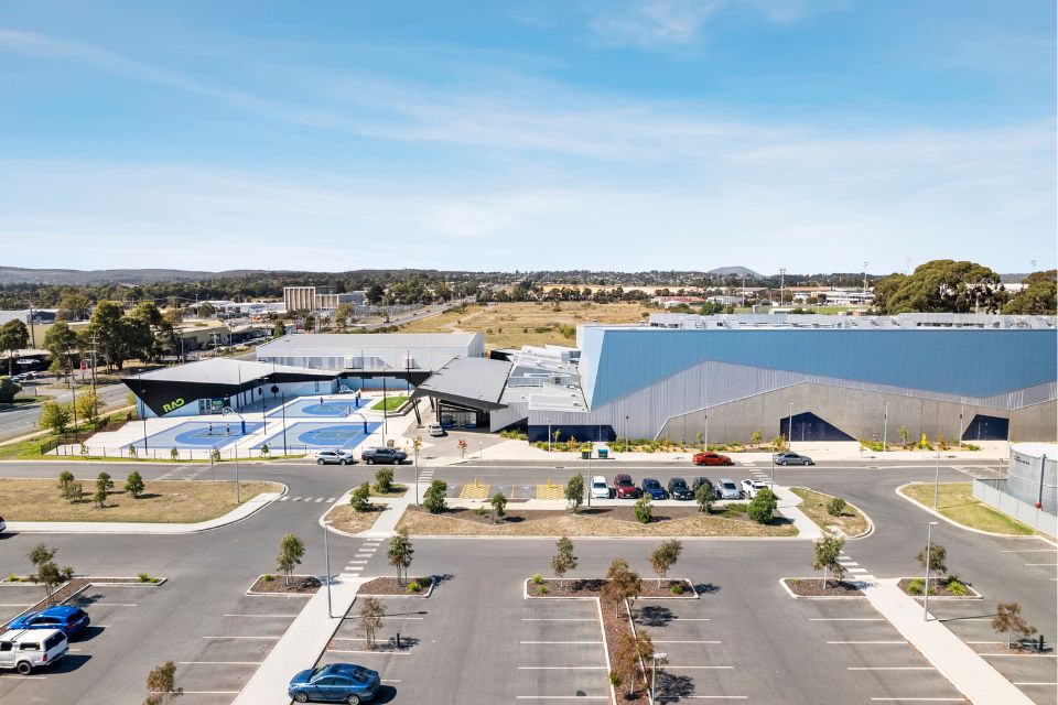 Aeirial view of the Ballarat Sports Events Centre showing buildings and 3 outdoor half-court basketball courts.