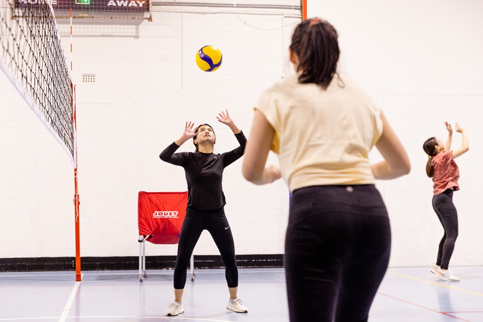 Women playing volleyball