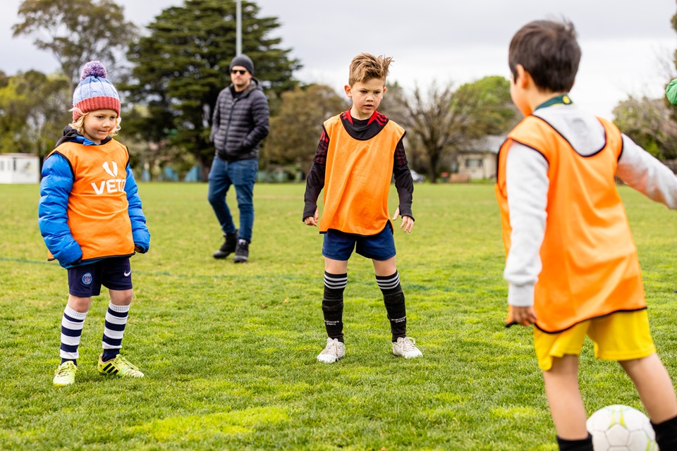 Kids kicking soccer ball