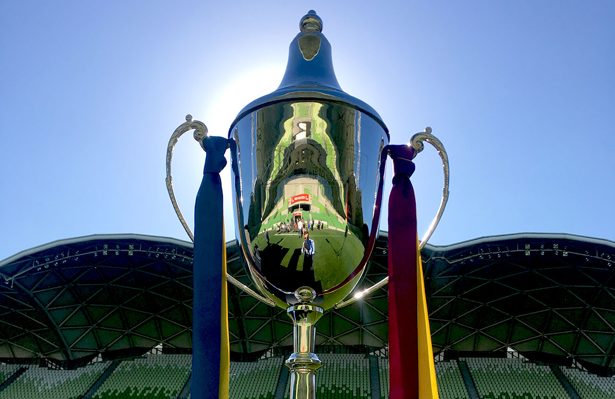 Closeup of the Rugby World Club Cup silhouetted against a cloudless blue sky