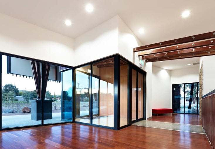Open space interior with polished wooden floor and natural lighting