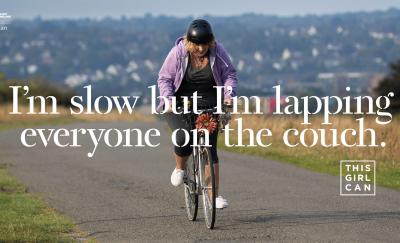 Sport England campaign poster of a woman on a bike with the caption "I'm slow but I'm lapping everyone on the couch".